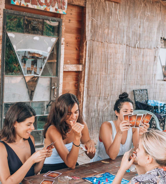 a group of women sitting around a table playing a game