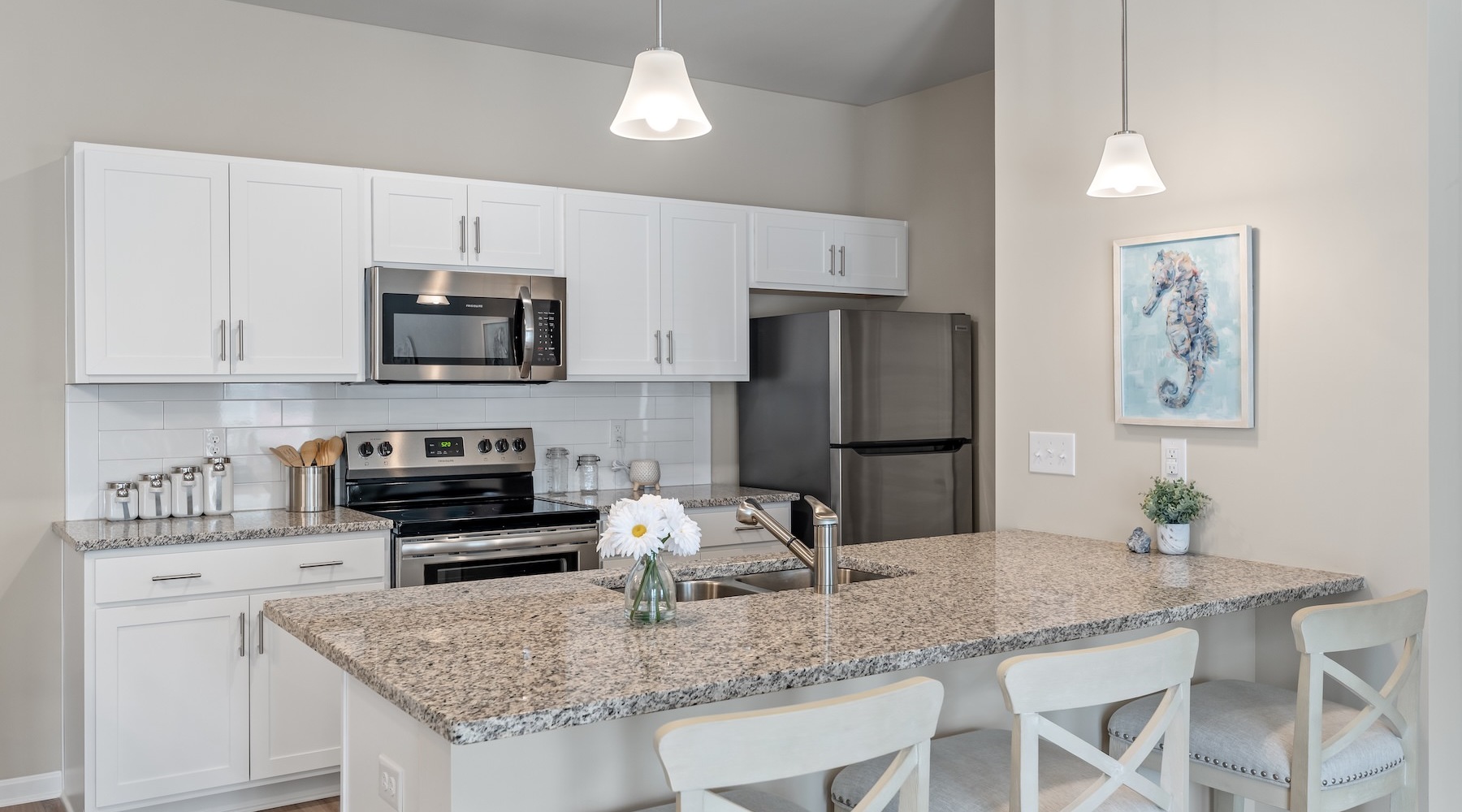 Kitchen with a large counter and bar stools