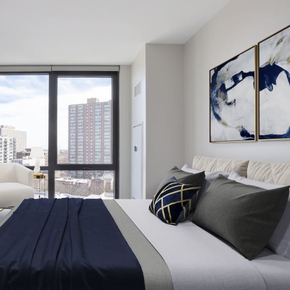 a bedroom with a large bed and a large window