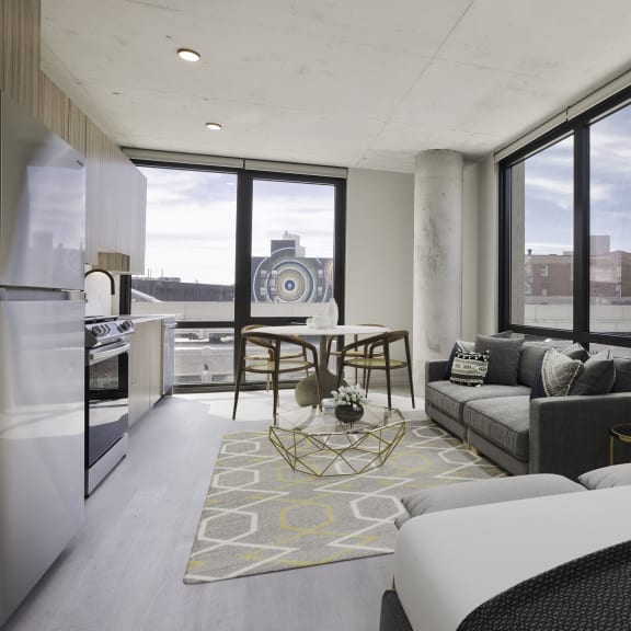 a living room filled with furniture and a large window