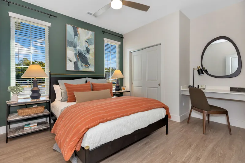 furnished bedroom with ceiling fan and built in desk