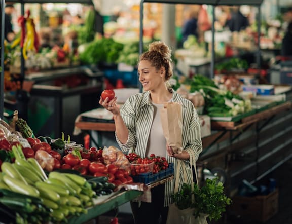 Woman Shopping for Vegetables at a Market