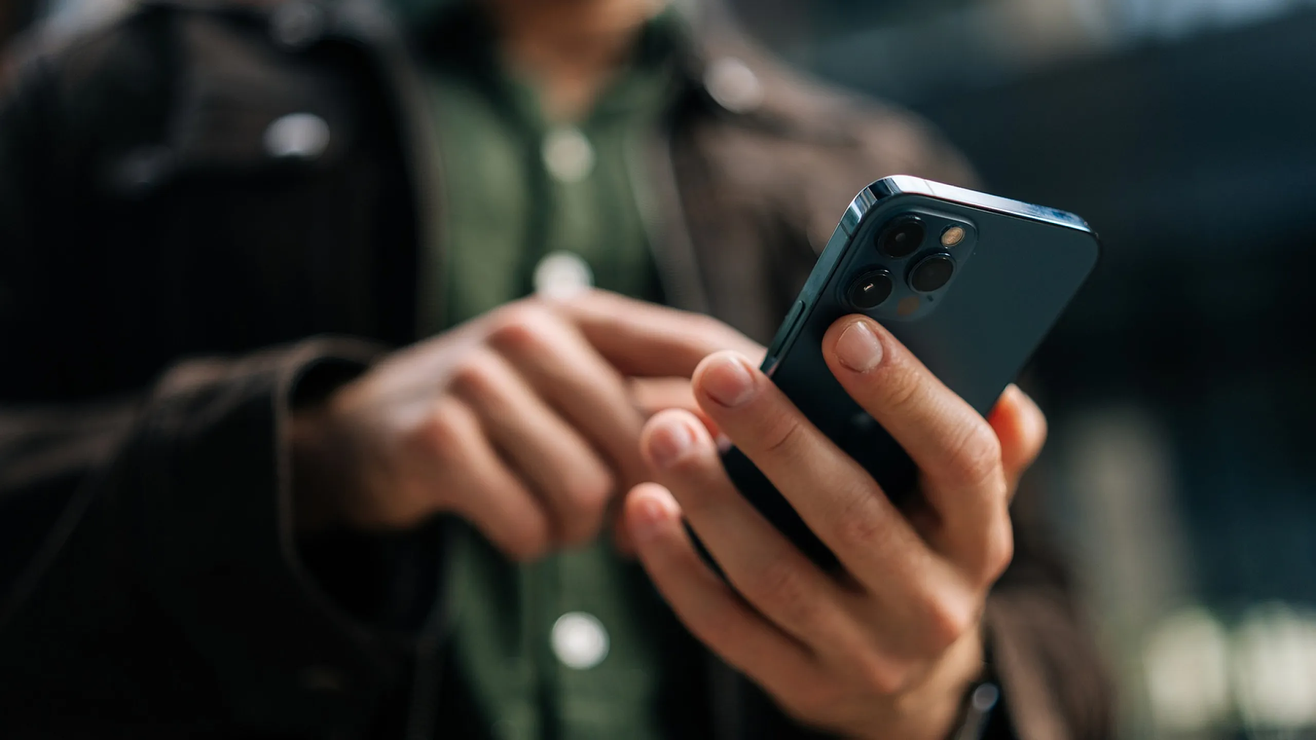 Close-up of a person using a modern smartphone, highlighting sleek design and advanced technology.