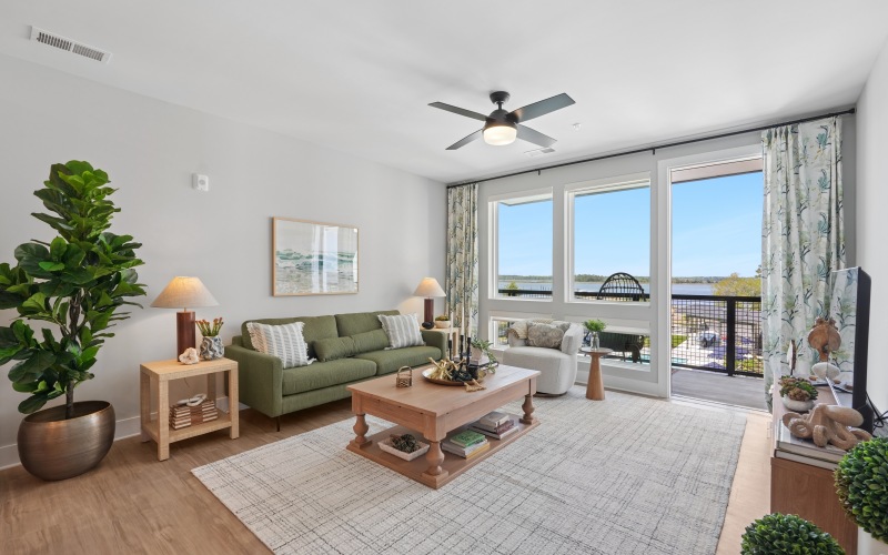 a living room with couch and a window with water view