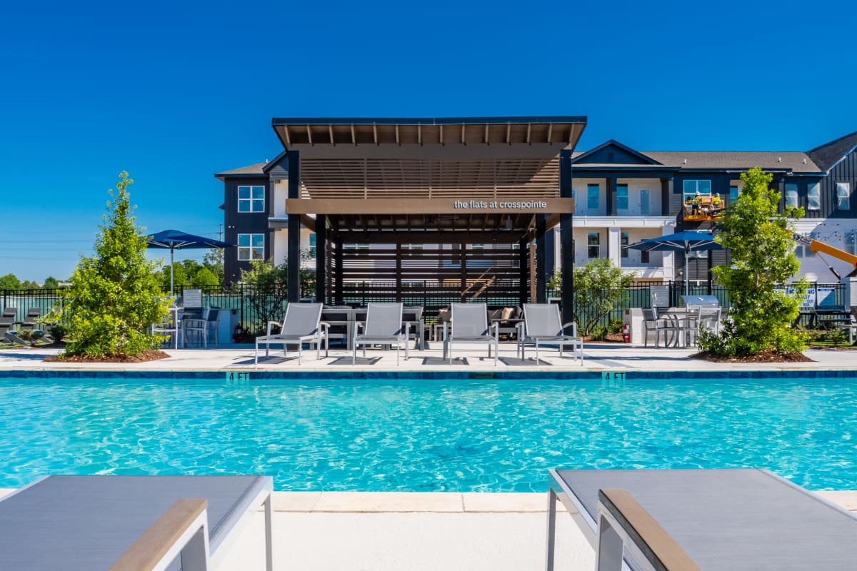 Outdoor swimming pool with lounge and blue water at The Flats at Crosspointe in Columbia, South Carolina