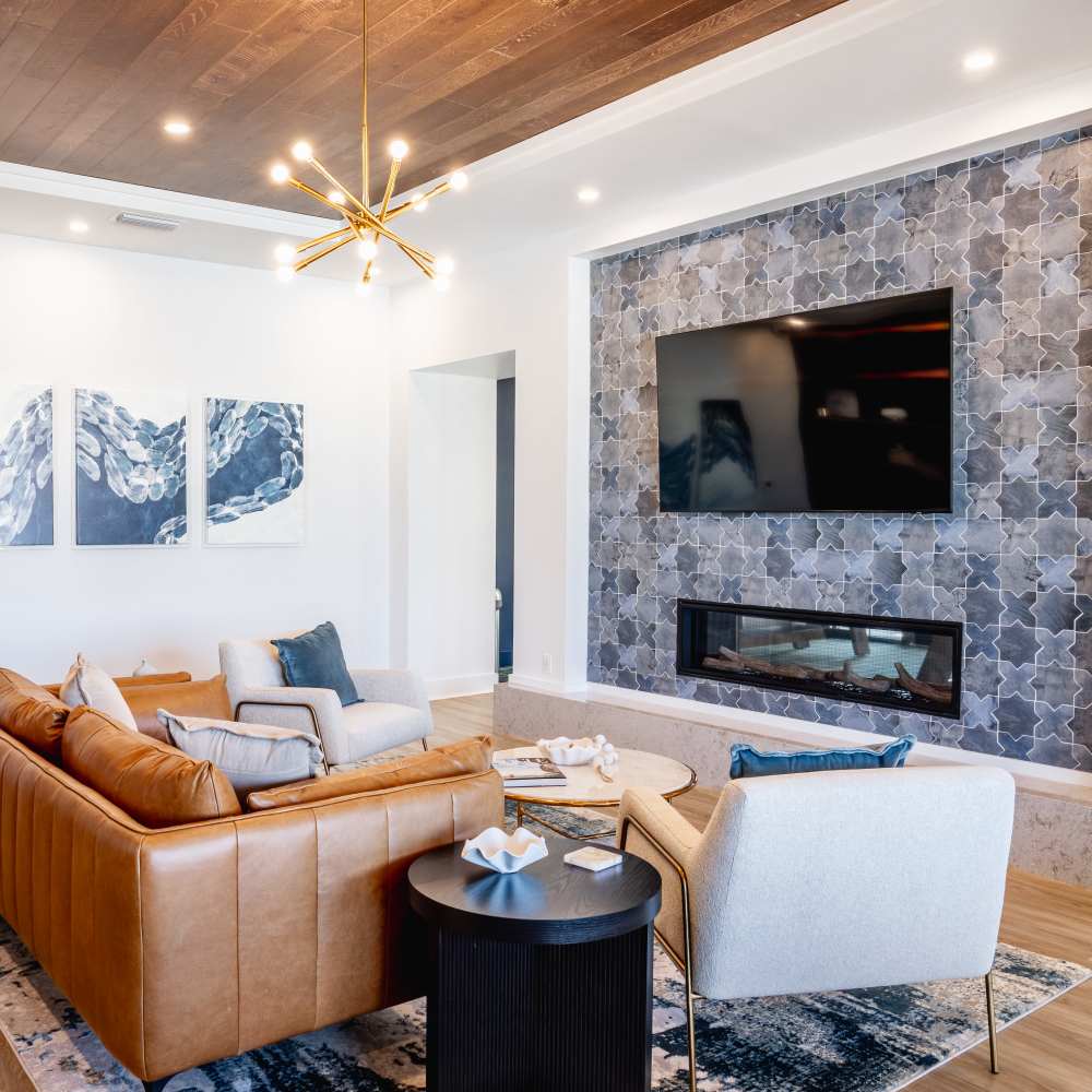 Clubhouse lounge with seating and entertainment wall at The Flats at Crosspointe in Columbia, South Carolina