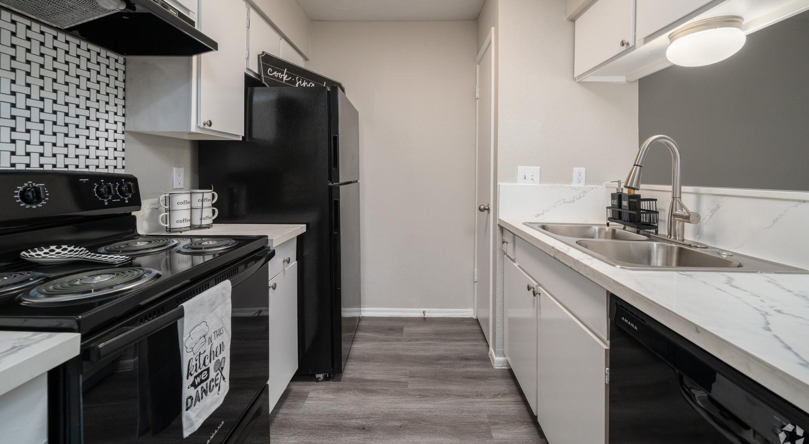 a kitchen with black appliances