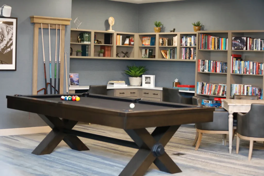 pool table and bookshelves at community