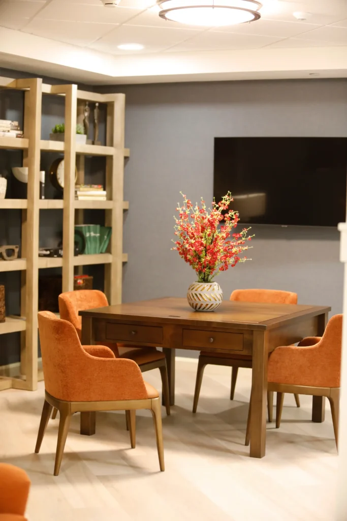 common area with table, chairs, and tv at community
