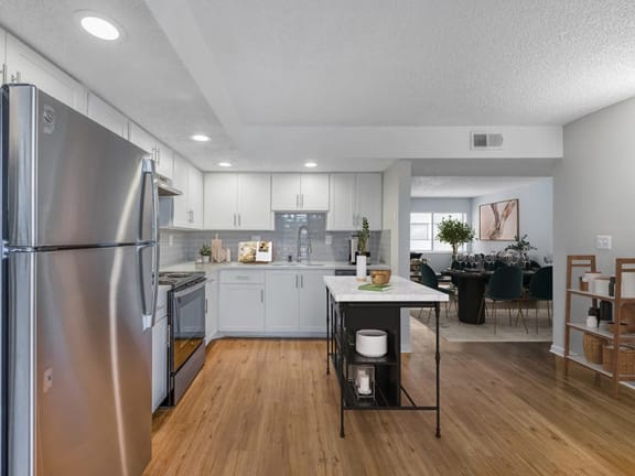 a kitchen with a center island next to a stove top oven