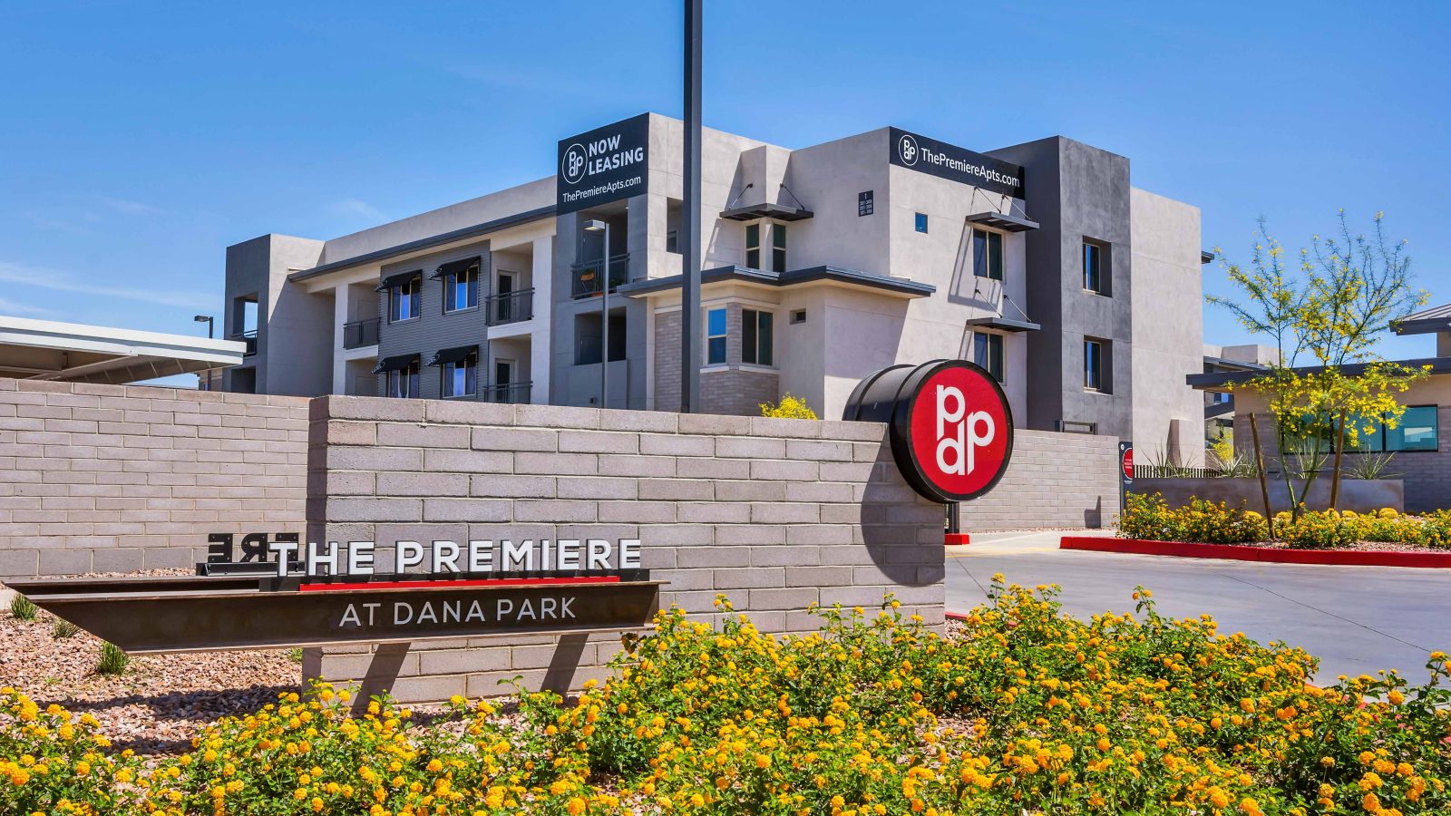 Entrance signage for The Premiere at Dana Park apartment complex.