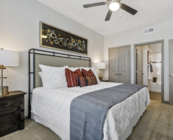 a bedroom with a bed and a ceiling fan