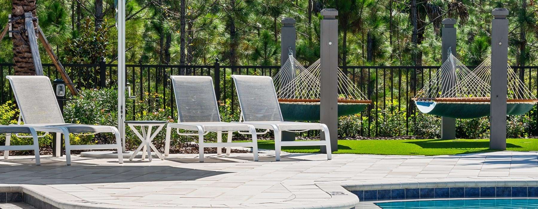 a pool with chairs and umbrella