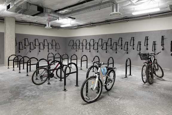 A bike rack with several bicycles parked in it.