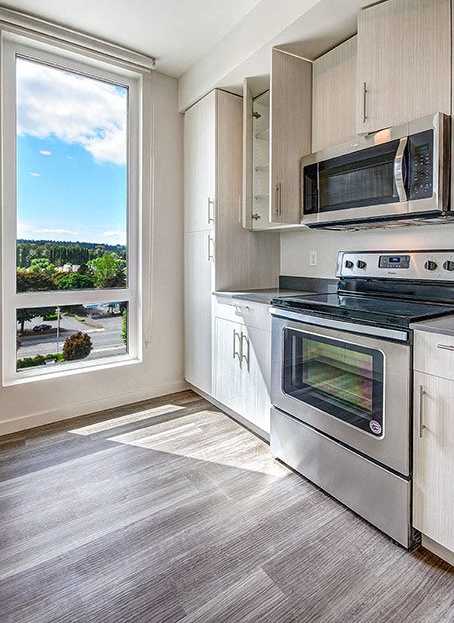 A modern kitchen with a stainless steel oven and microwave. at Ravello Apartments, Redmond, WA, 98052
