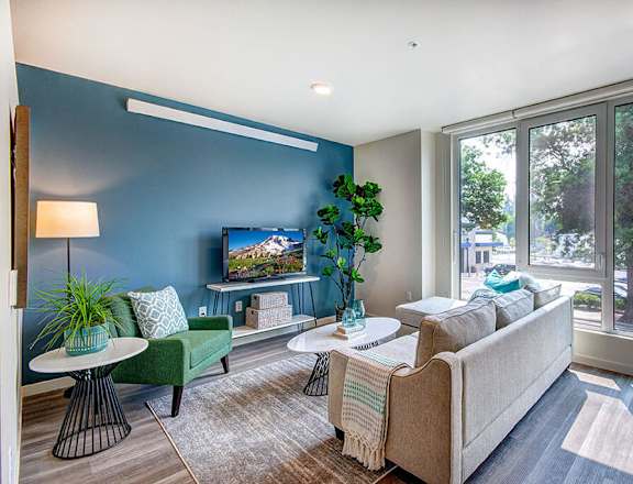 A living room with a couch, chair, and a television. at Ravello Apartments, Redmond, WA, 98052