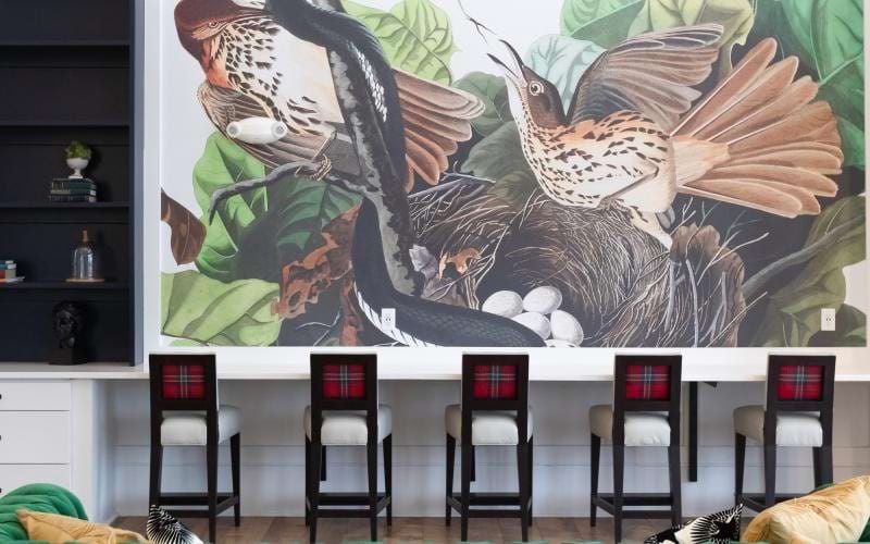 a green couch with a wall mural
