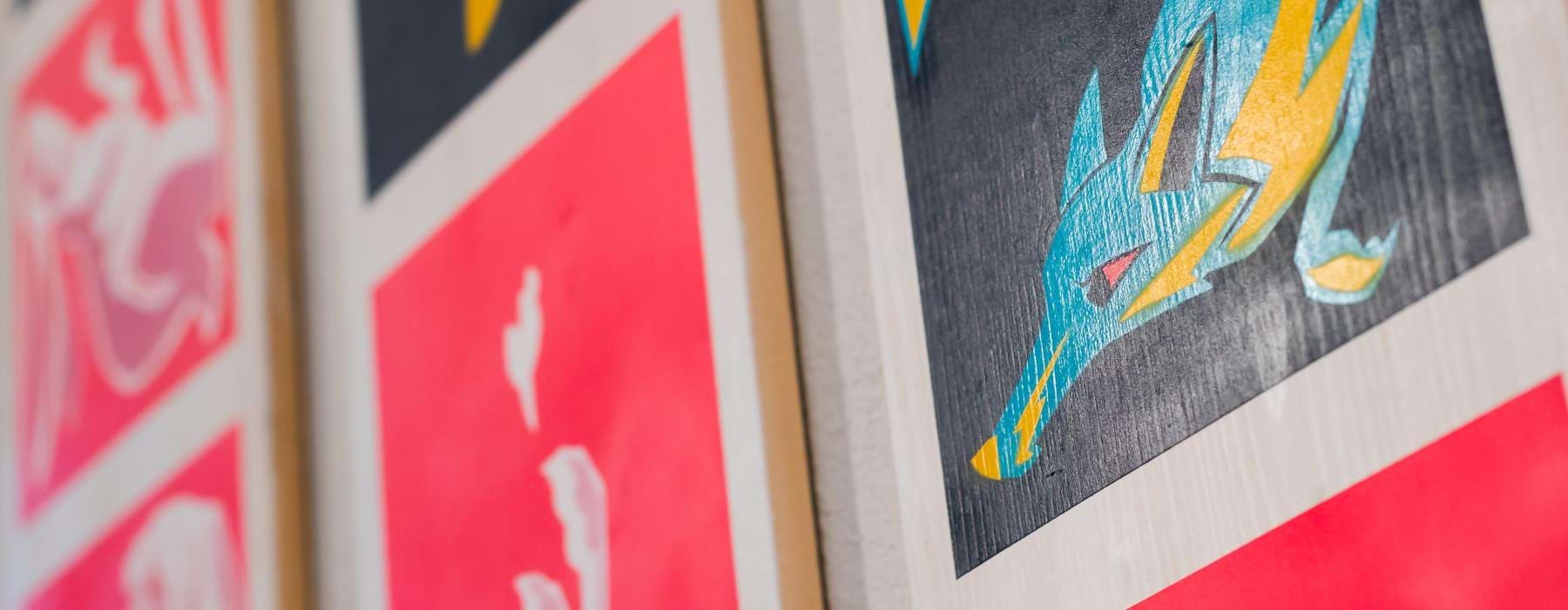 a group of colorful paintings on a wall