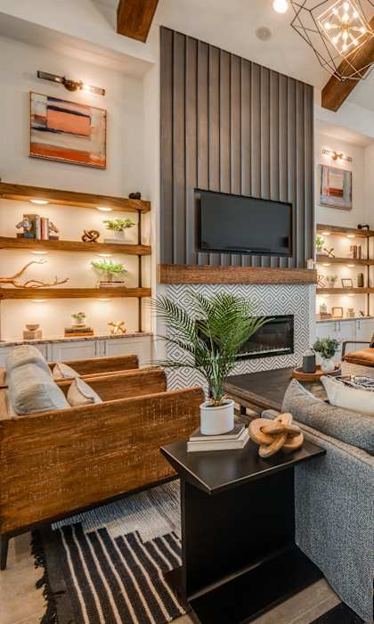 A modern living room with a wooden coffee table and a grey sofa.