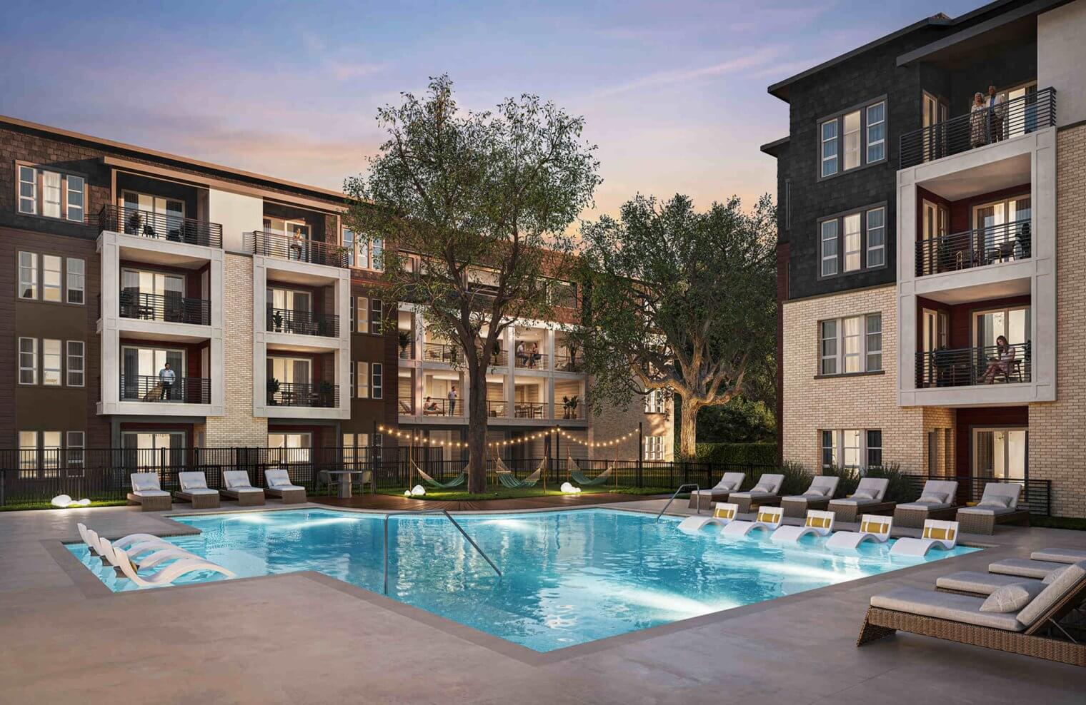 The peaceful resort pool at Otto on the Trail at dusk, with ambient lighting creating a warm and relaxing escape for residents.