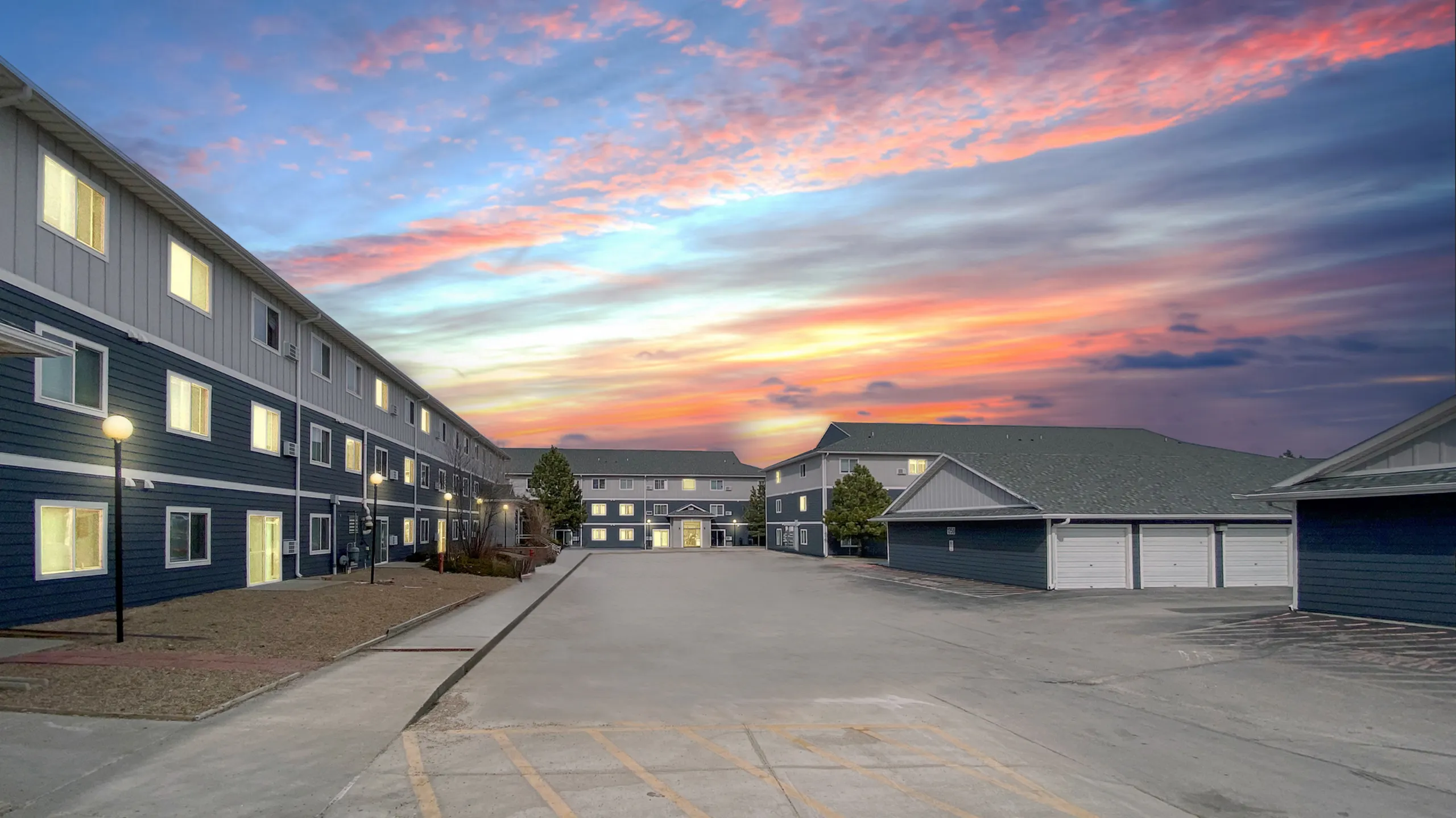 Charming apartment complex at sunset showcasing modern architecture and serene surroundings.