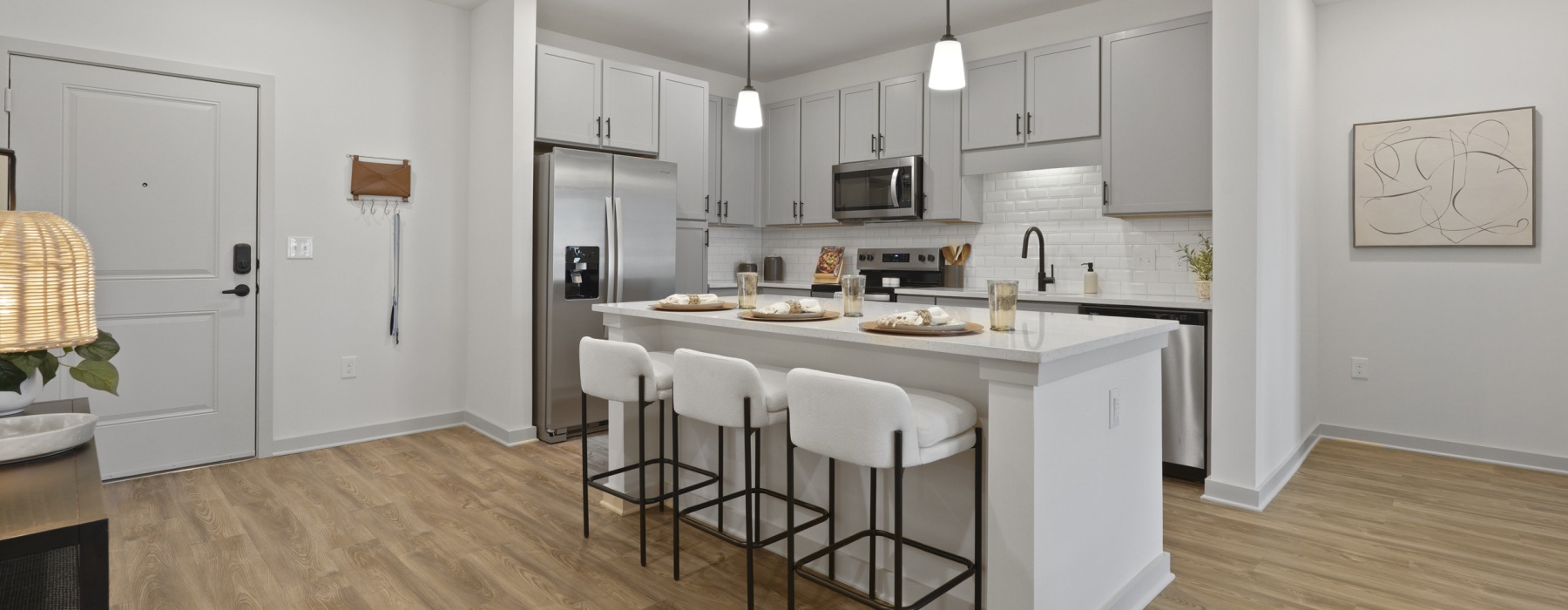 a kitchen with an island and chairs