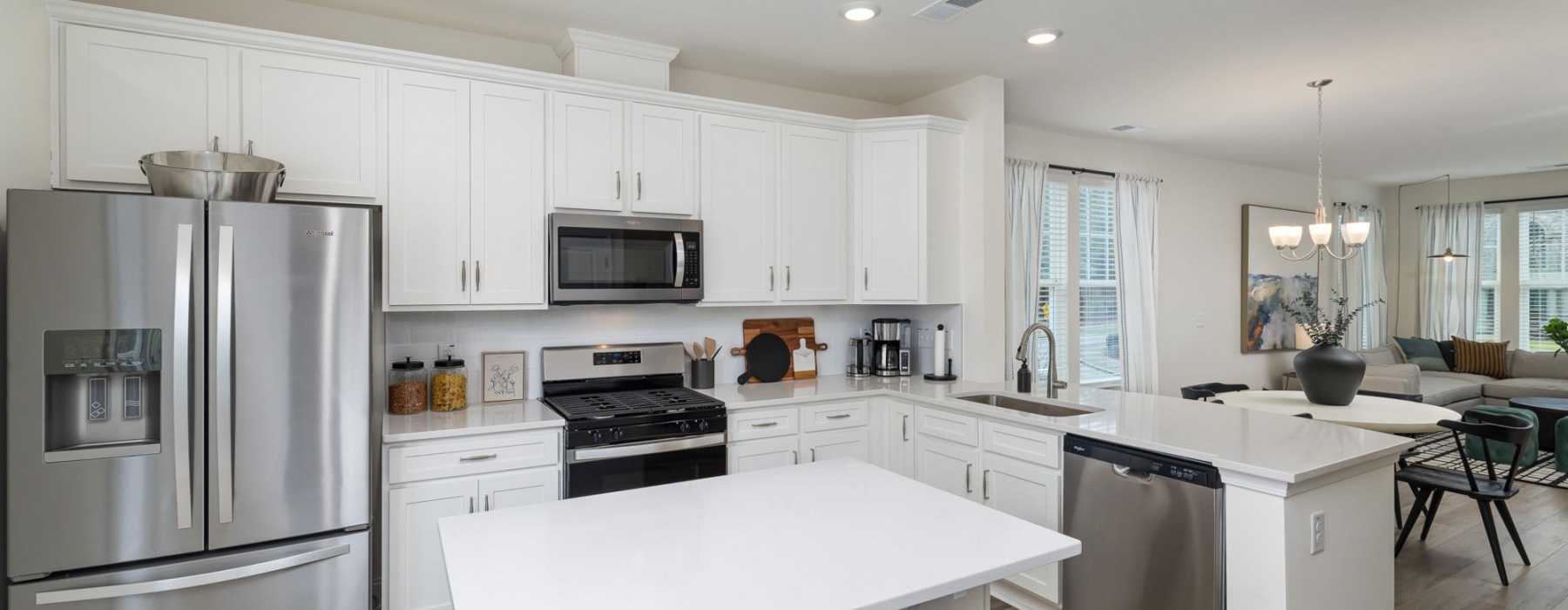 kitchen with stainless steel appliances and white cupboards