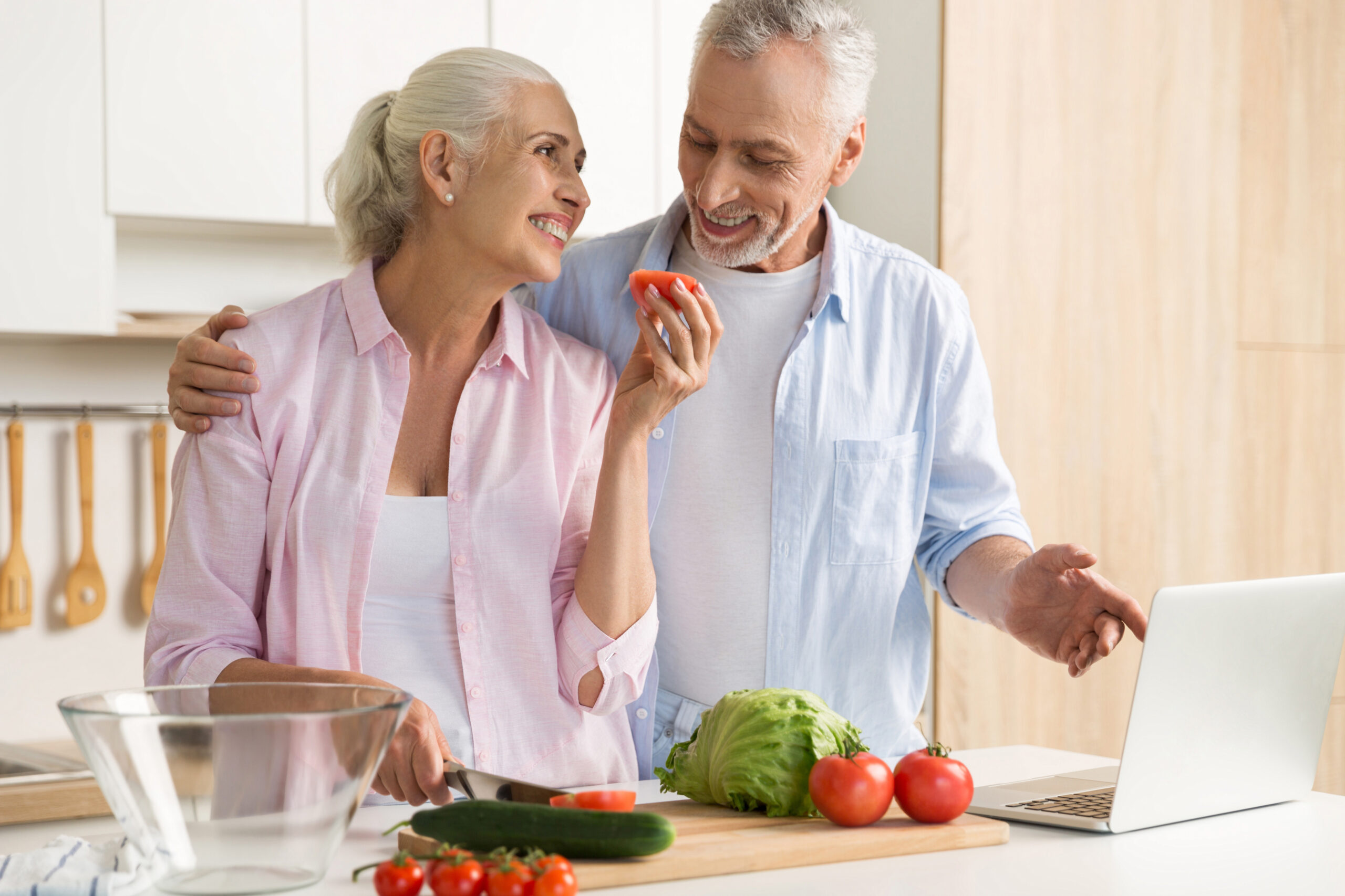 Senior couple preparing food together at All Seasons