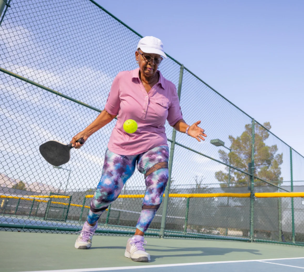 senior woman playing pickleball