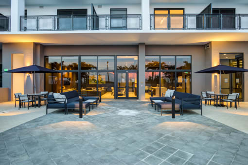 Apartments In Miami For Rent - MB Station - Community Outdoor Lounge Area With Plush Couches, Pillows, Patio Sets With Chairs