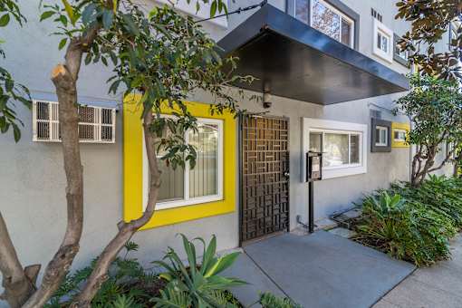 A house with a yellow window and a black gate.