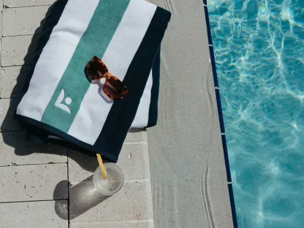A towel sits next to a swimming pool at Livano Avondale. 