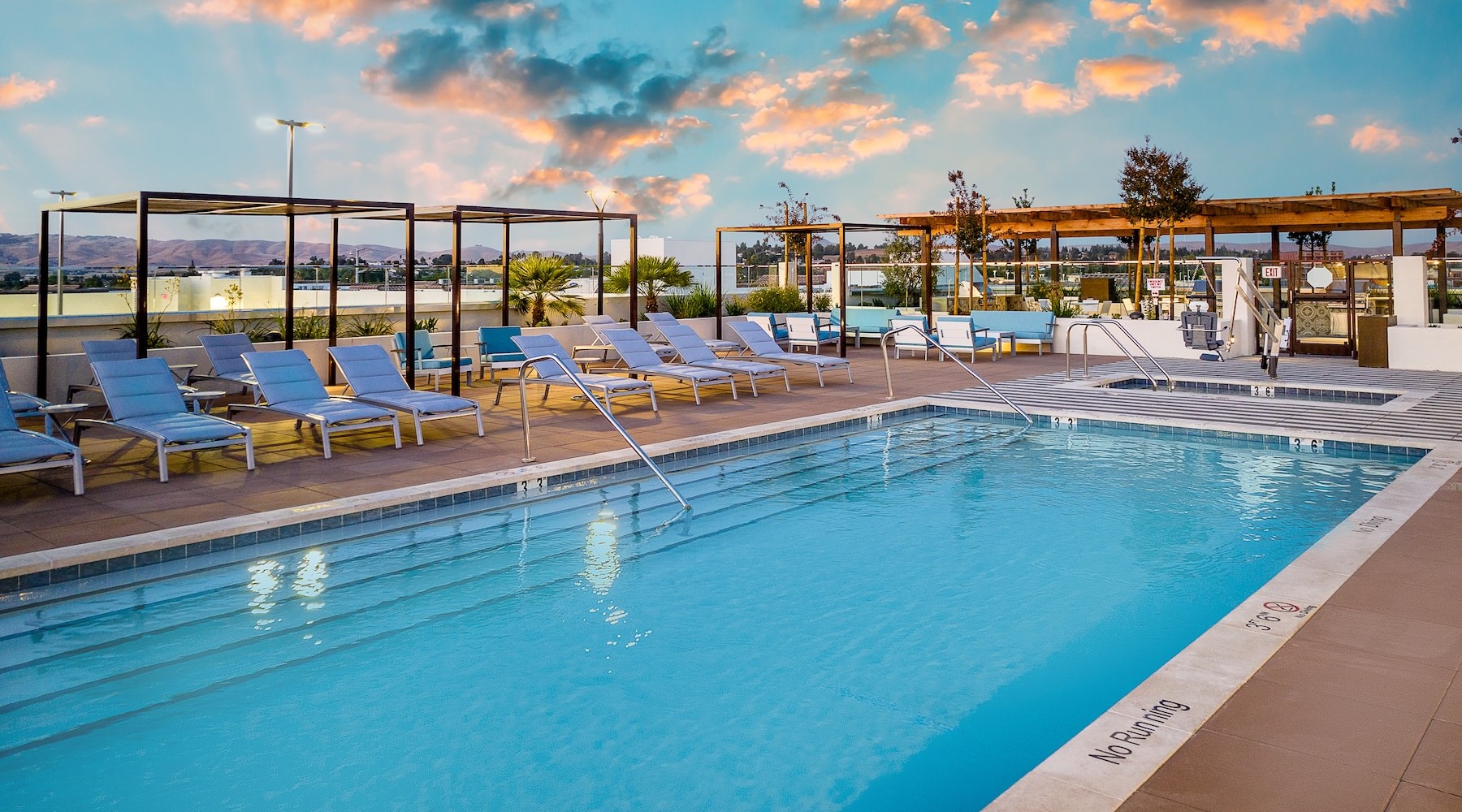 a swimming pool with lounge chairs