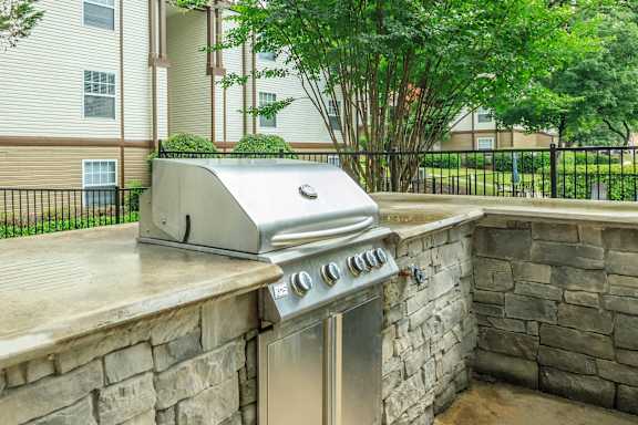 A stainless steel grill is on a stone patio.at 400 Winchester, Georgia, 30339