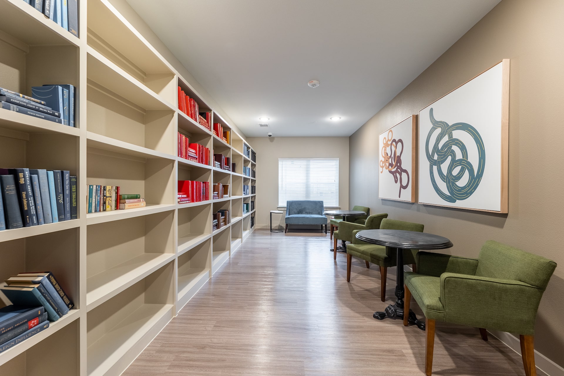Spacious resident reading area with bookshelves at our Manor, TX apartment complex