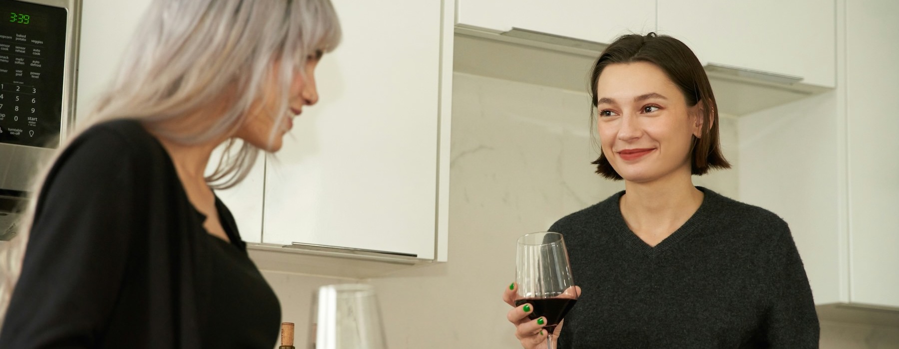 a couple of women holding wine glasses