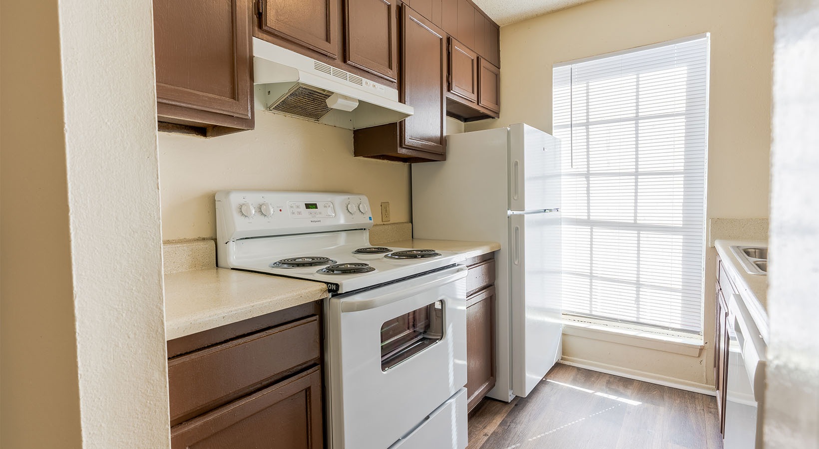 a kitchen with brown cabinetry