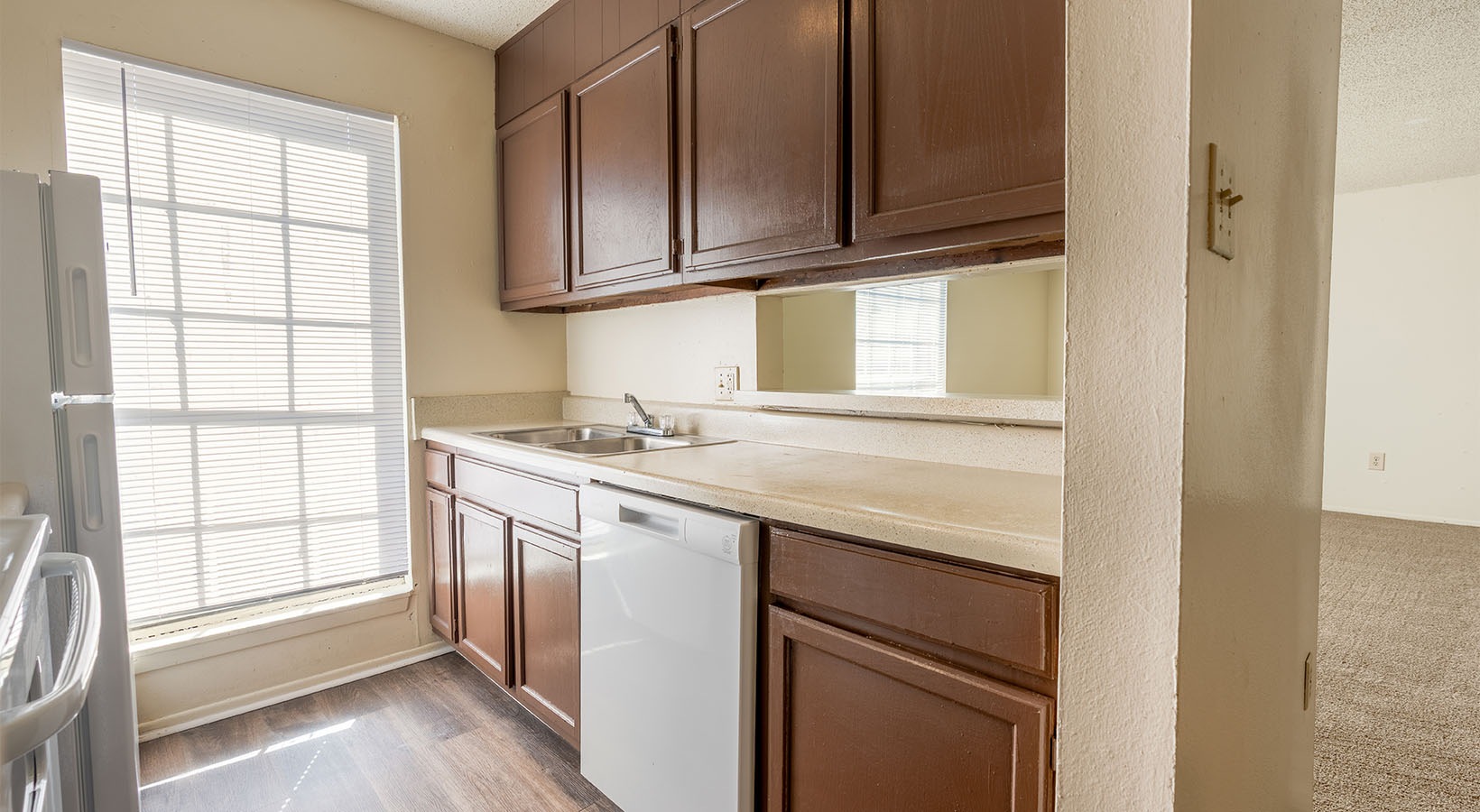a kitchen with brown cabinetry