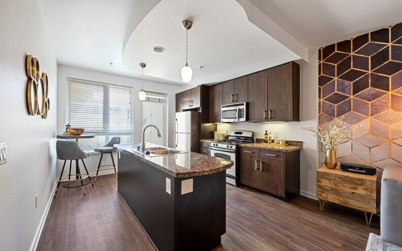 a kitchen with an island and a wood floor