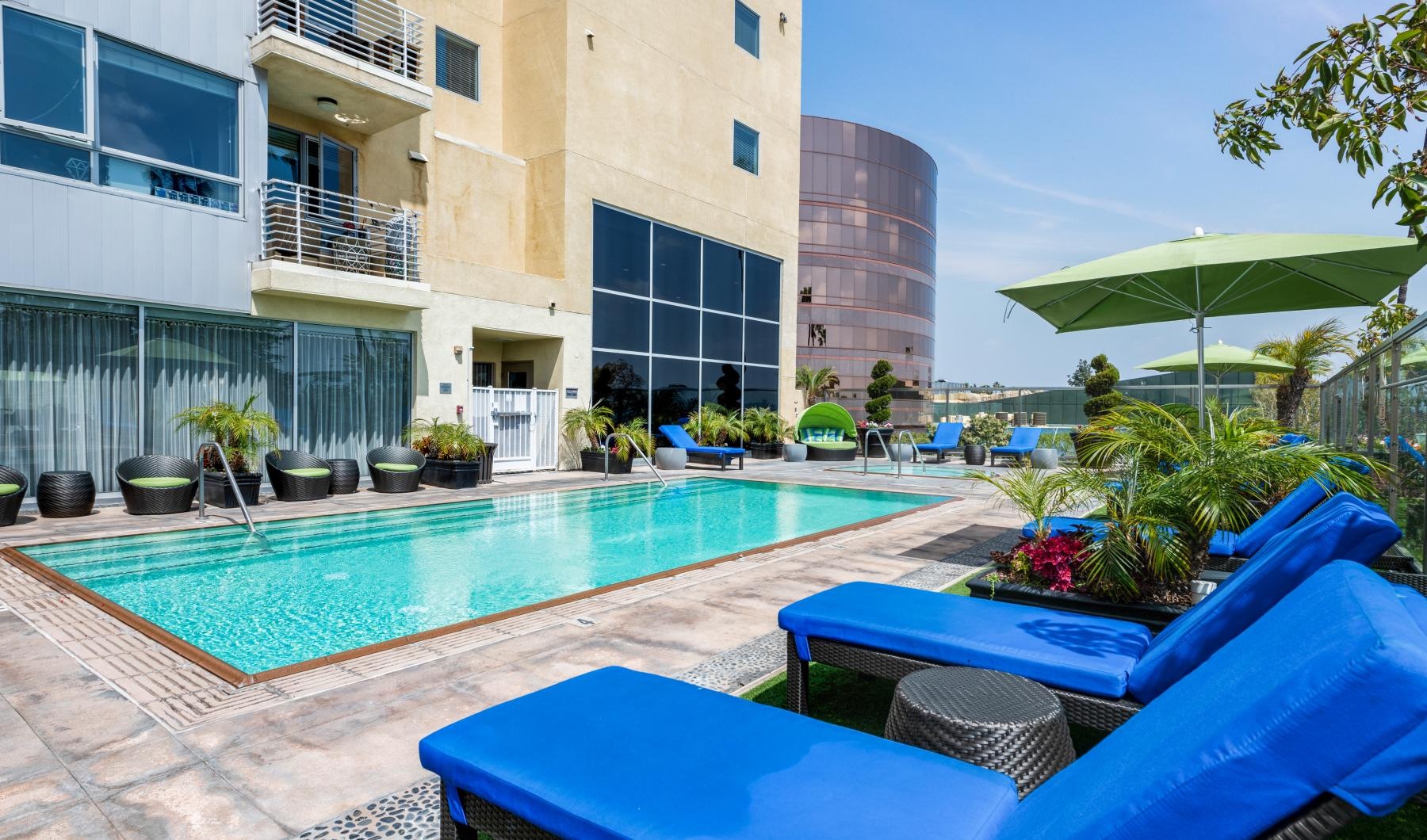 a pool with chairs and umbrellas
