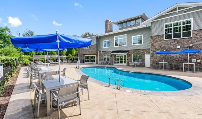 a swimming pool and chairs next to the property
