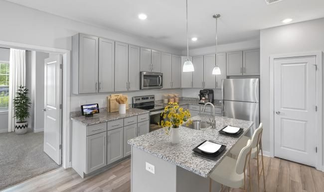 a kitchen with white cabinets