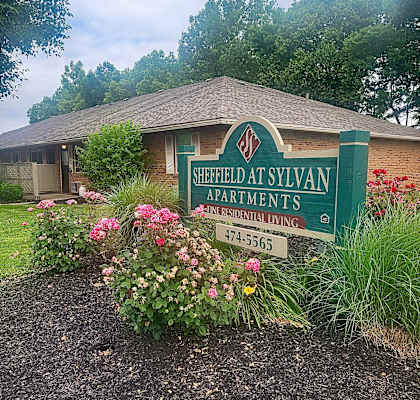 a photo of the street sign in front of the shelter at sylvan apartments