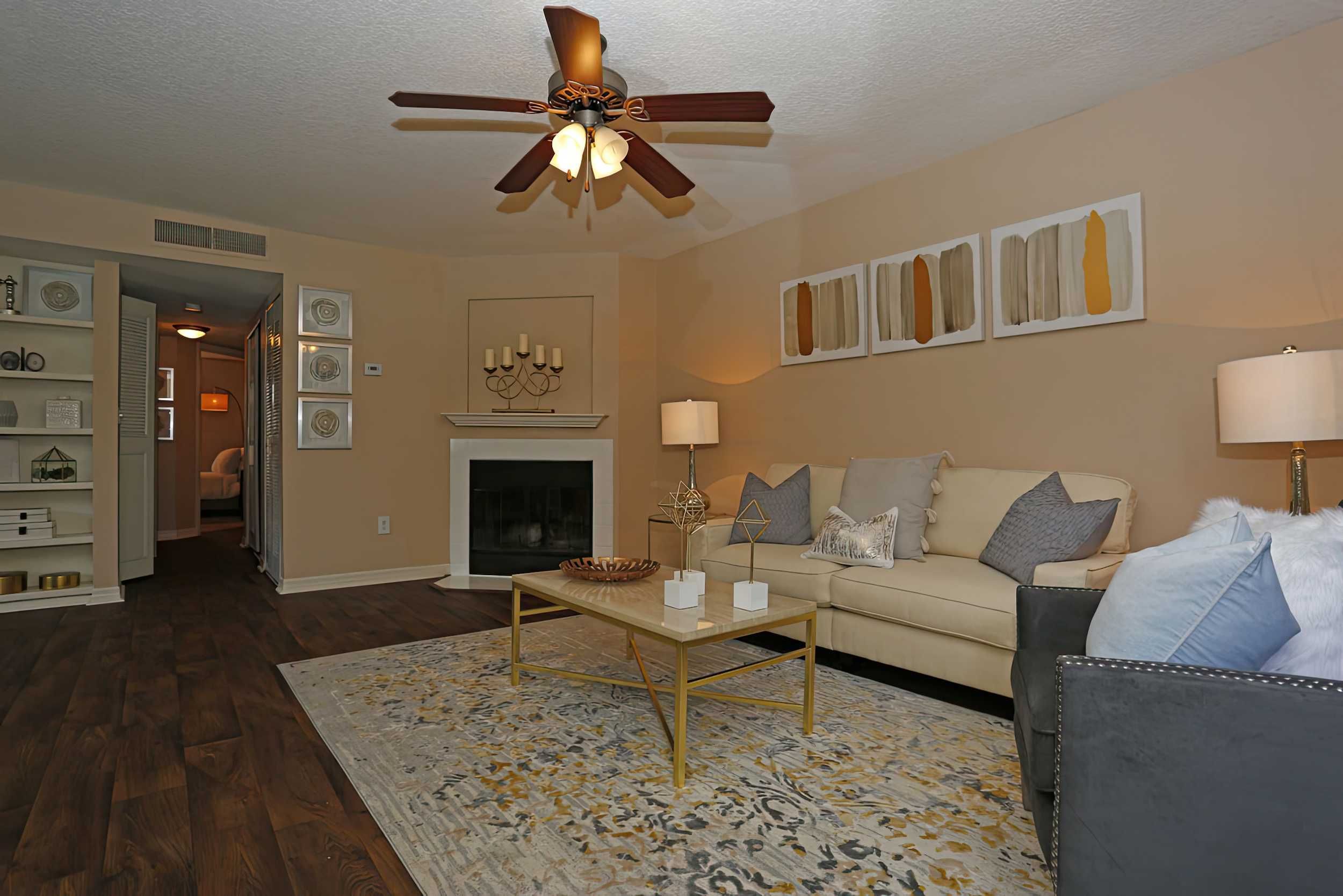 A cozy living room featuring a cream sofa, decorative art, and a warm atmosphere.