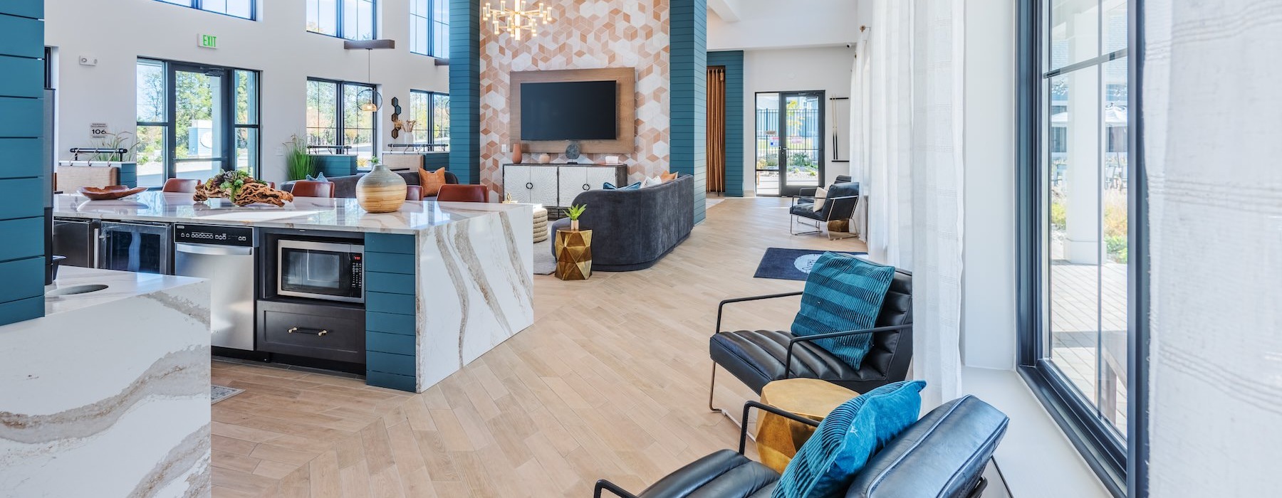 a clubroom with an island, chairs and a tv