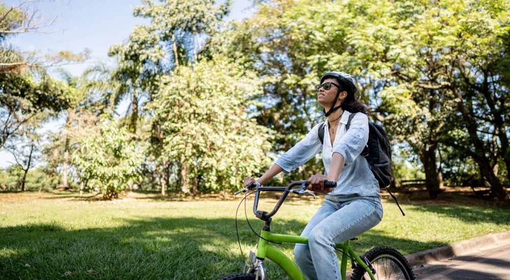 Resident woman cycling at a park near The Montclair in Houston, Texas