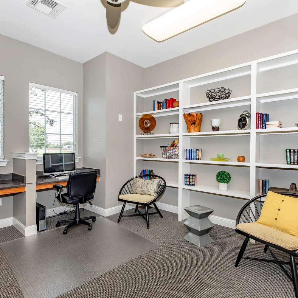 Office with desk, shelves, and seating at Point Royale Apartments in Victoria, Texas