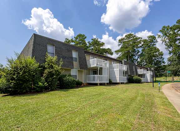 A modern house with a grey roof and white walls. at Peachtree Place Apartments, South Carolina, 29210