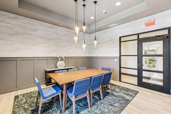 A conference room with a long table at The Arboretum Apartments, Farmingville, NY 11738