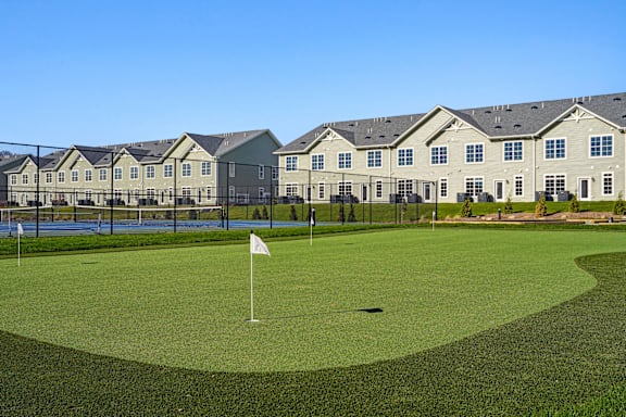 A golf course with a green and a flag on it at The Arboretum Apartments, Farmingville